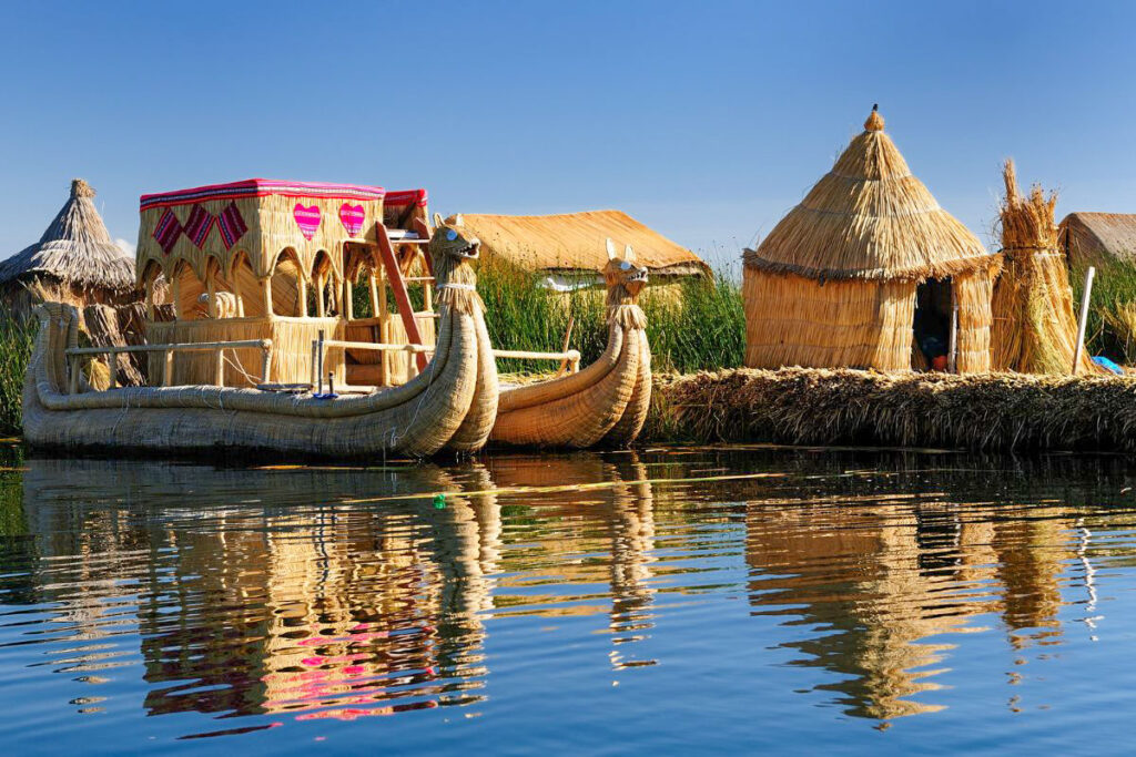 Top 7 Unique Travel Destinations to Visit in 2025 Traditional reed boats and huts of the Uros people floating on the shimmering waters of Lake Titicaca, surrounded by lush reeds and under a clear blue sky.